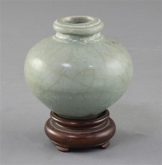 A Chinese Longquan celadon ovoid jar, Song - Yuan dynasty, 7.5cm, wood stand